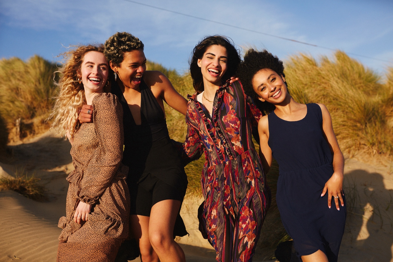 A diverse group of models of different heritages and skin tones together at golden hour
