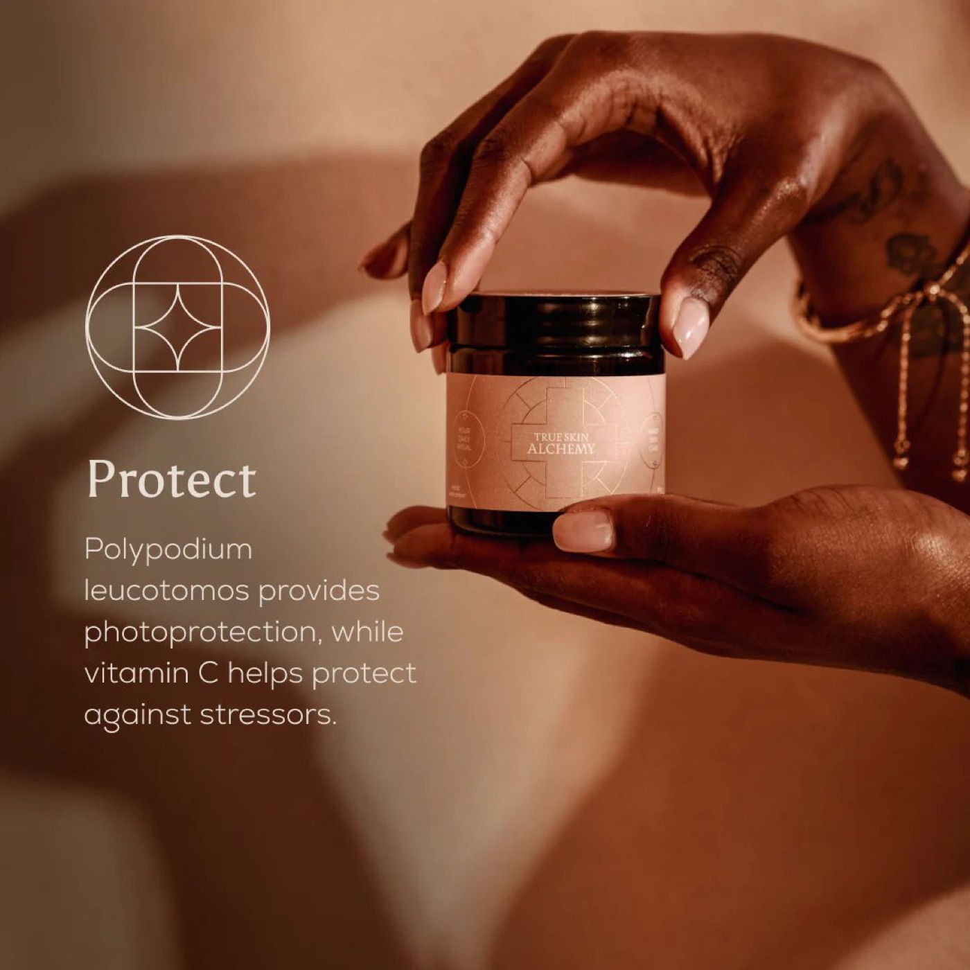 A hand model holding a skincare jar