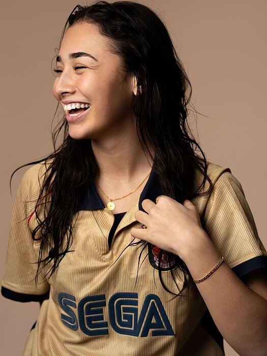 A petite model laughing in a lifestyle campaign shoot