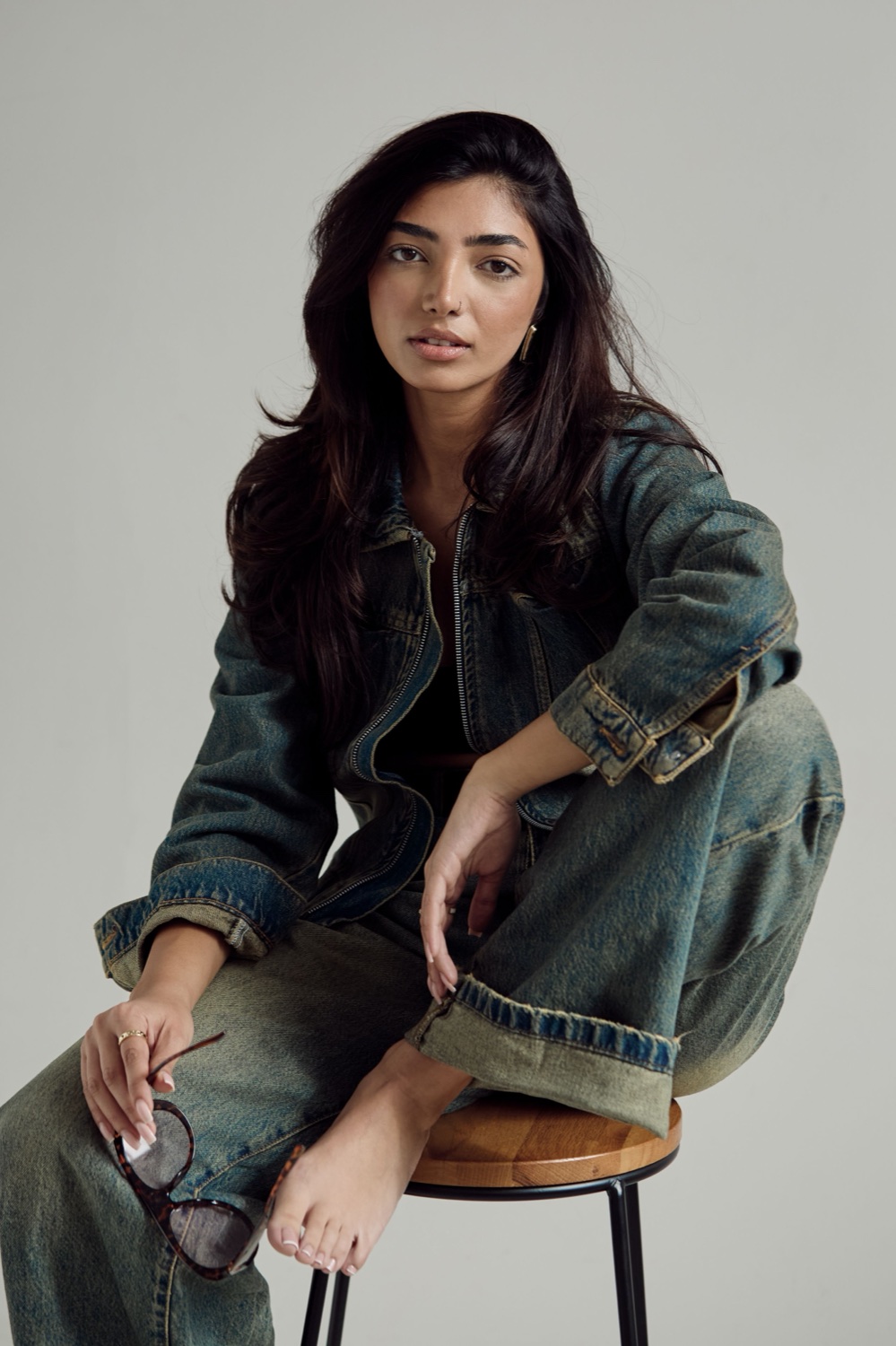 South Asian model in a denim jacket and jeans, fashion editorial