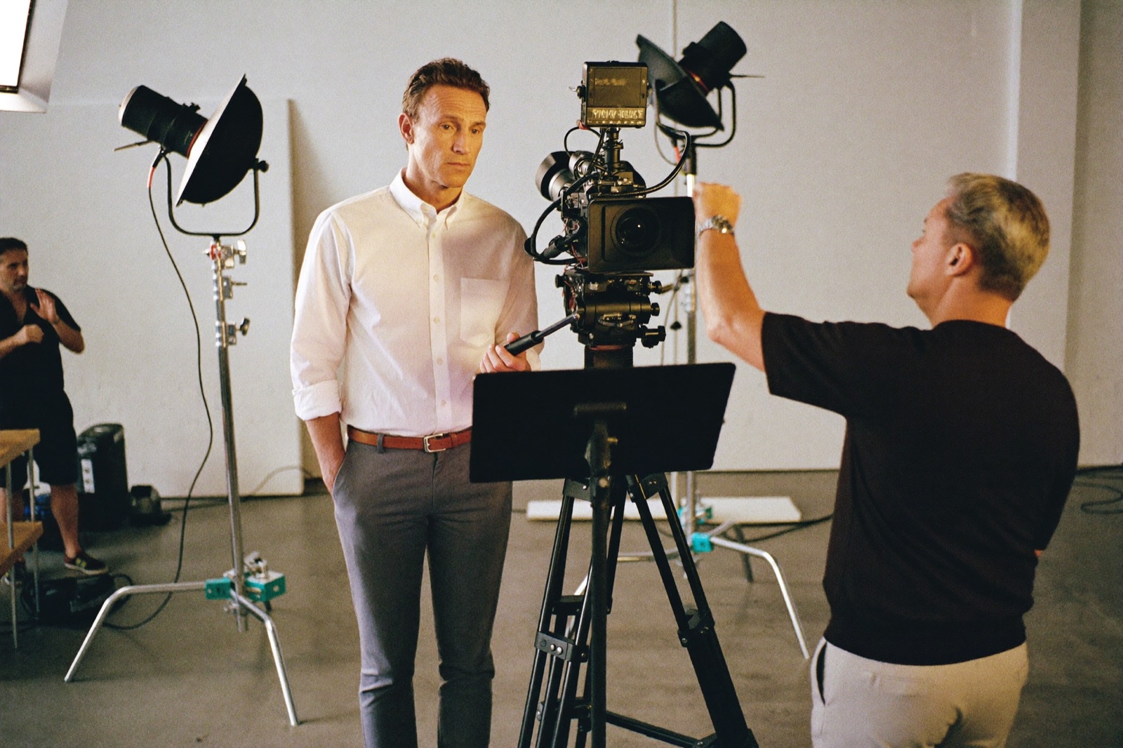 A model on a commercial advertising set, checking a monitor with a director between takes